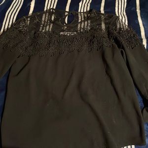 i am selling a blouse with a open back and very top with floral designs